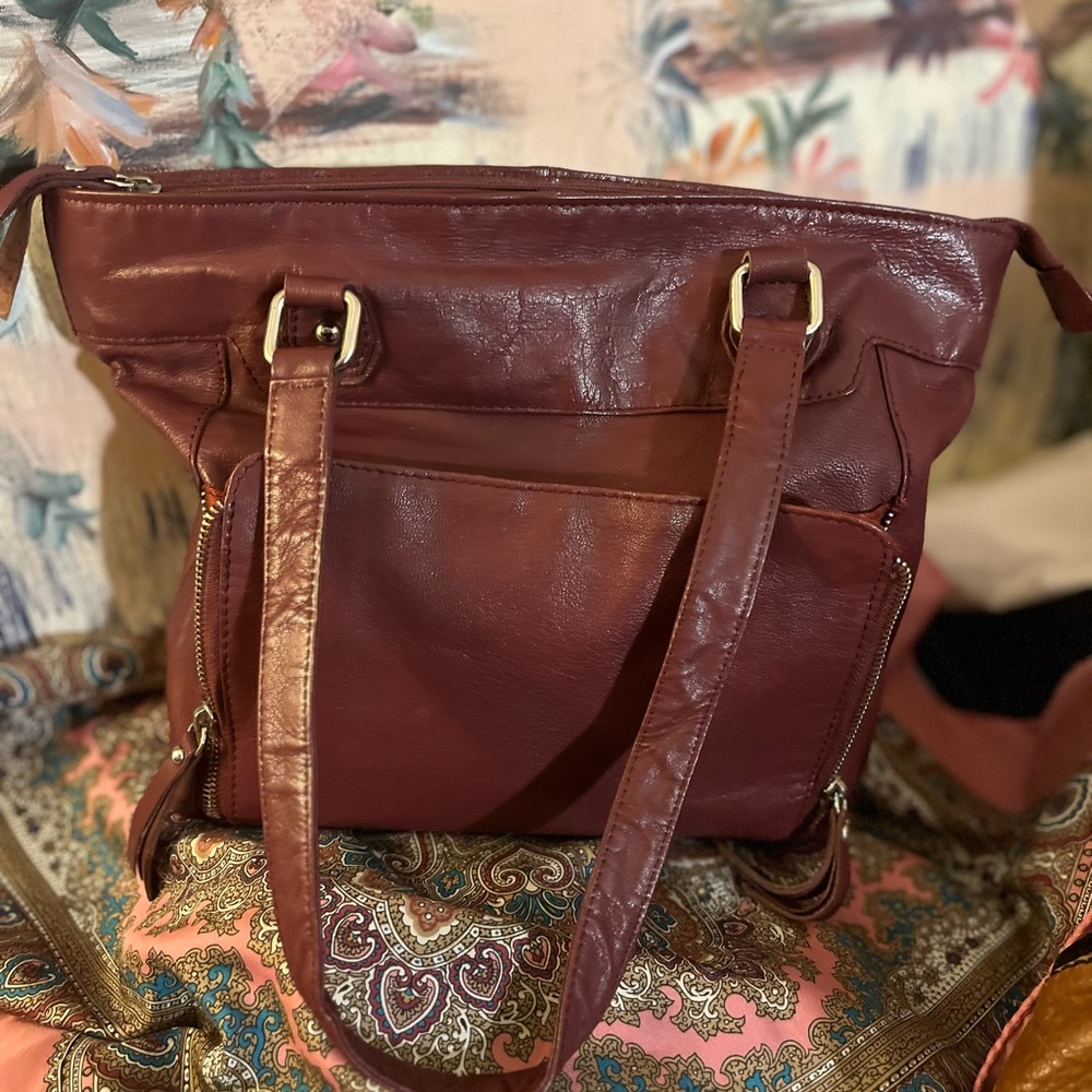 American leather company burgundy bag that makes a lot of faces. He’s a comedian